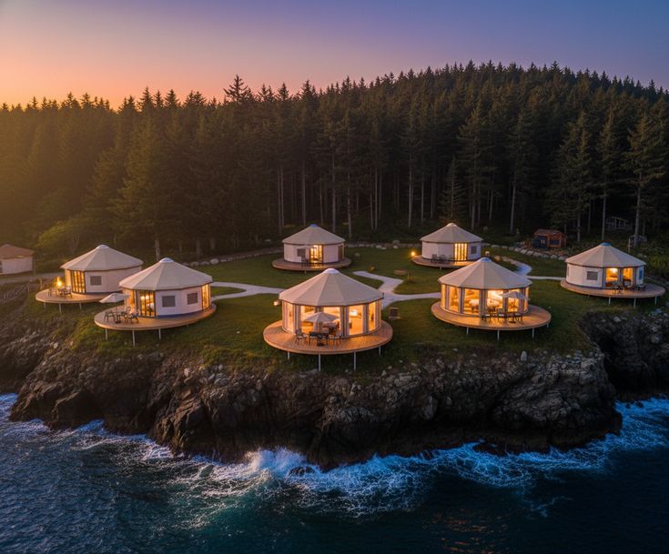 Luxury oceanfront glamping resort featuring modern dome-style cabins surrounded by forest, offering unique hotel accommodation with scenic coastal views.