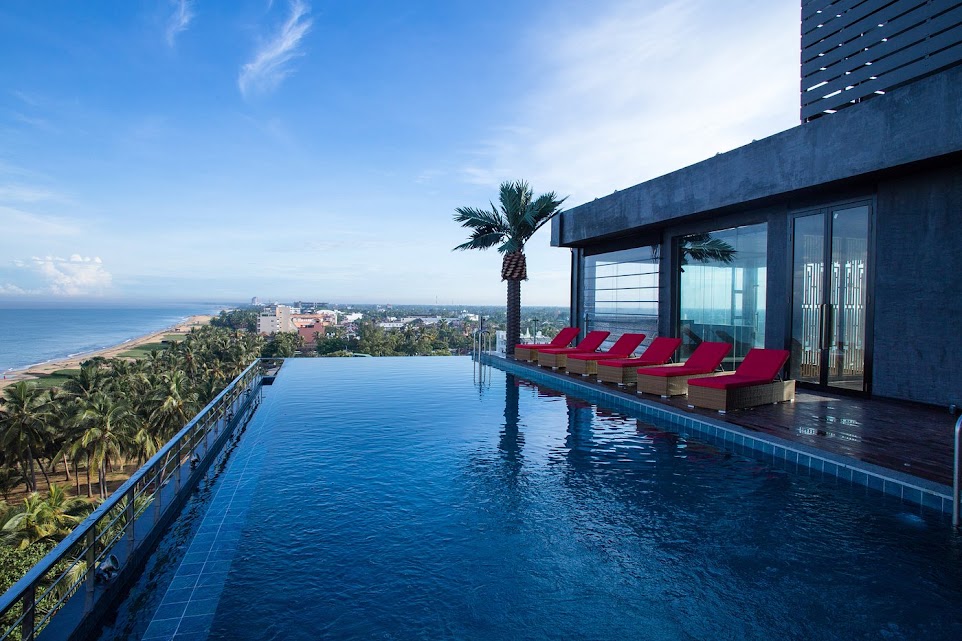 Luxury hotel rooftop infinity pool overlooking the beach and ocean