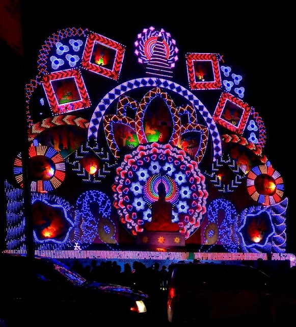 Vibrant Vesak Festival display glowing at night.